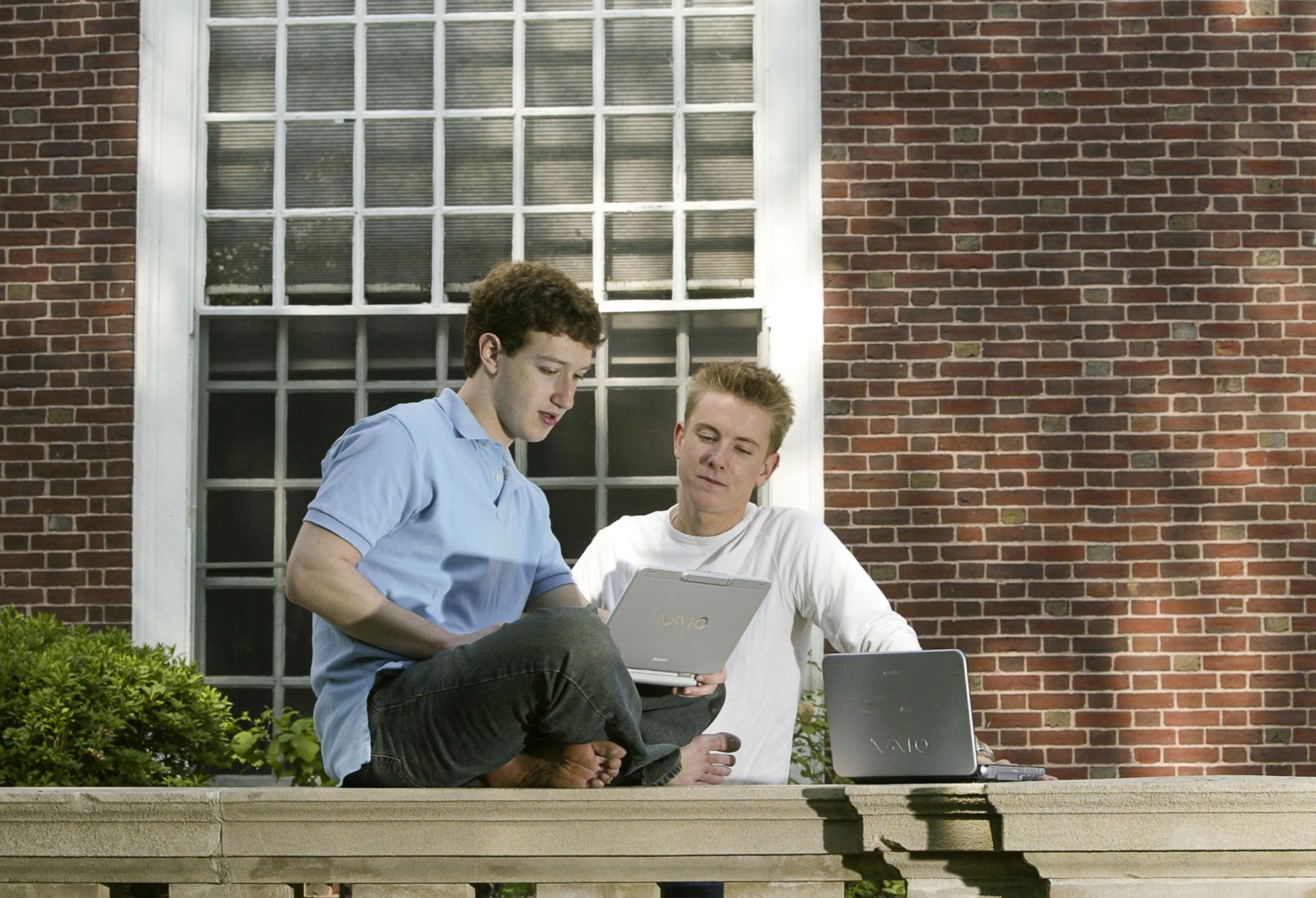 Zuckerberg, left, and Facebook co-creator Chris Hughes work on computers at Harvard University in Cambridge, Massachusetts, in May 2004. This was a few months after they launched Facebook from Zuckerberg's dorm room.