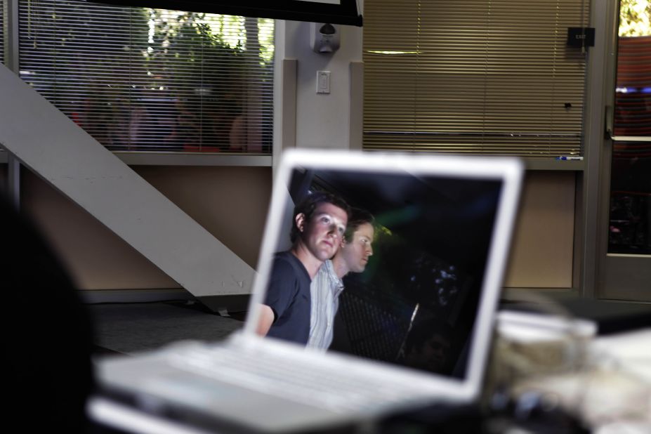 Zuckerberg and Facebook Groups product manager Justin Shaffer are reflected in a laptop at the end of a Facebook news conference in October 2010. Zuckerberg had announced three new features, including a new way to form groups. 