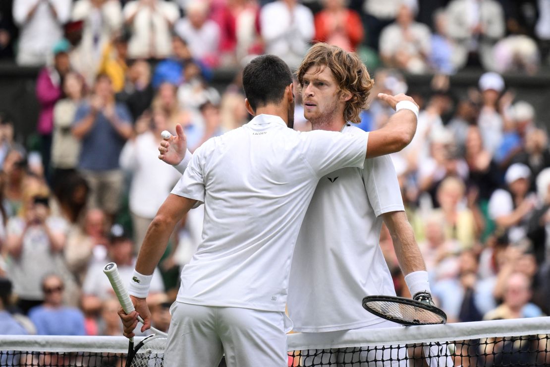 Novak Djokovic and Andrey Rublev embrace after the thrilling clash.