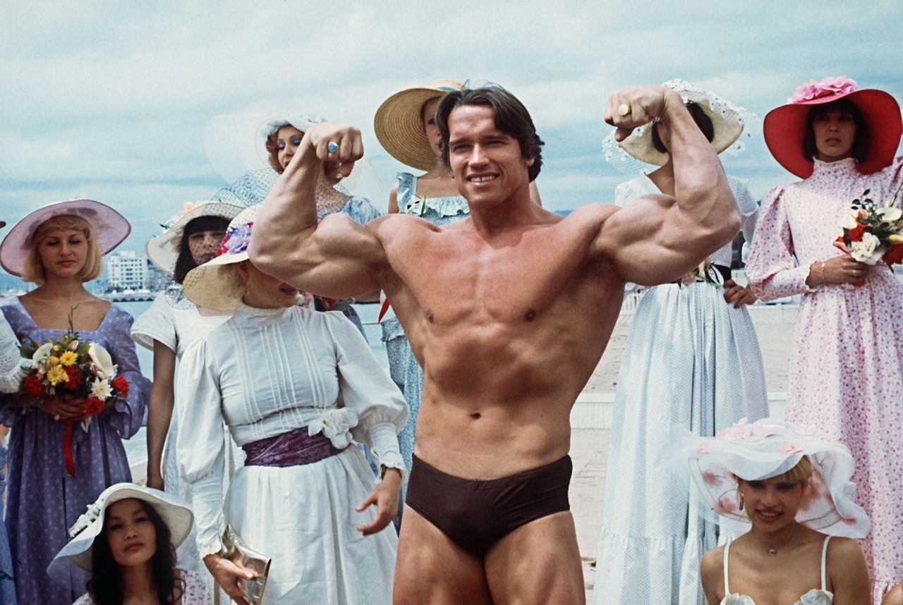 CANNES, FRANCE: Picture taken 19th May 1977 of American actor Arnold Schwarzenegger during the 38th Cannes film festival. The actor presented Pumping Iron, a documentary whom spreads his fame beyond bodybuilding circles. Arnold Schwarzenegger was born 30th June 1947 in the small isolated village of Graz, Austria. Now, he is chairman of the Inner-City Games Foundation, this program covers 10 city's and is continuing to grow. He poses 21th June 2003, new threat to beleaguered California governor. AFP PHOTO (Photo credit should read AFP/AFP via Getty Images)