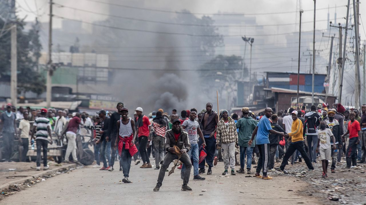 Kenyan opposition supporters react and throw stones towards Kenya Police officers during demonstrations in Nairobi, Kenya on July 12, 2023.