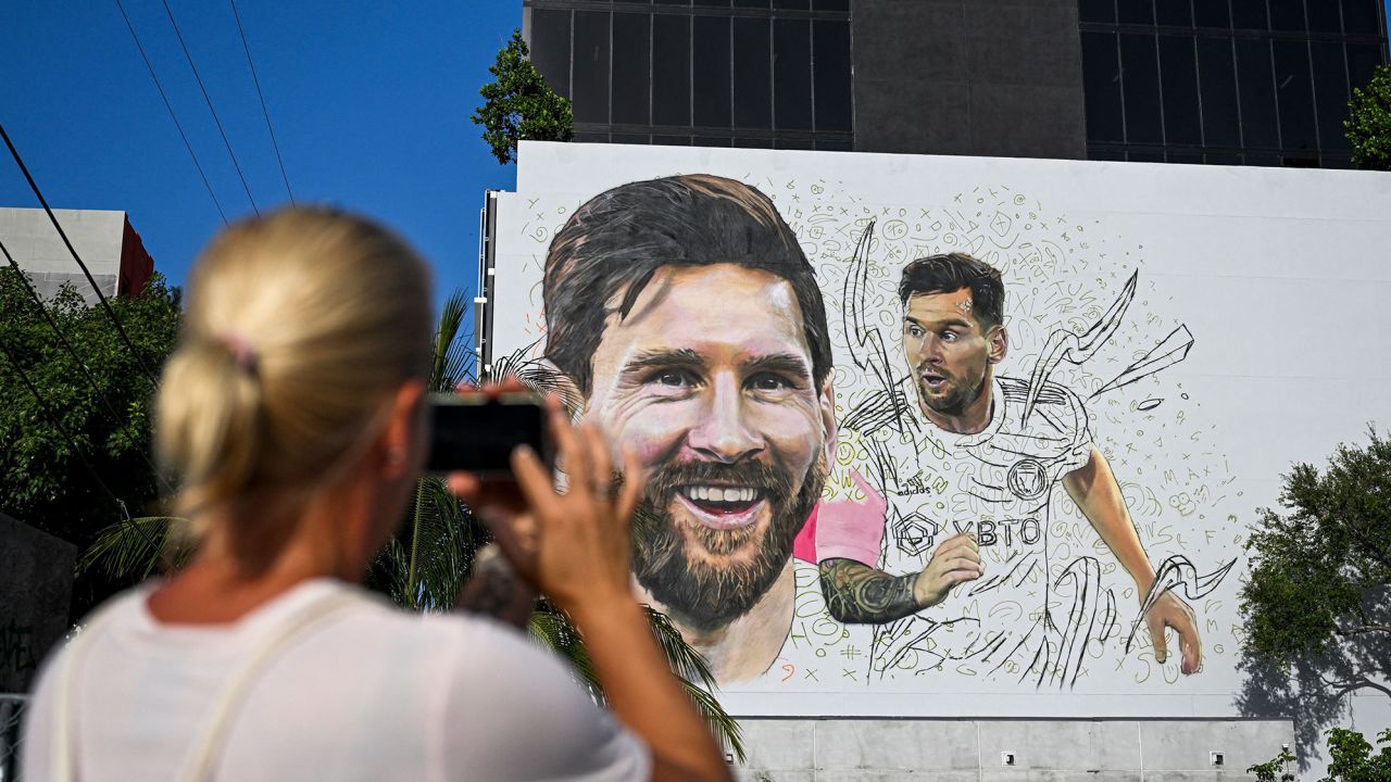 A woman takes a photo of Argentine artist Maximiliano Bagnasco's giant mural of international soccer star Lionel Messi in Wynwood, Miami's art district, in Miami, Florida on July 10, 2023. (Photo by CHANDAN KHANNA / AFP) / RESTRICTED TO EDITORIAL USE - MANDATORY MENTION OF THE ARTIST UPON PUBLICATION - TO ILLUSTRATE THE EVENT AS SPECIFIED IN THE CAPTION (Photo by CHANDAN KHANNA/AFP via Getty Images)