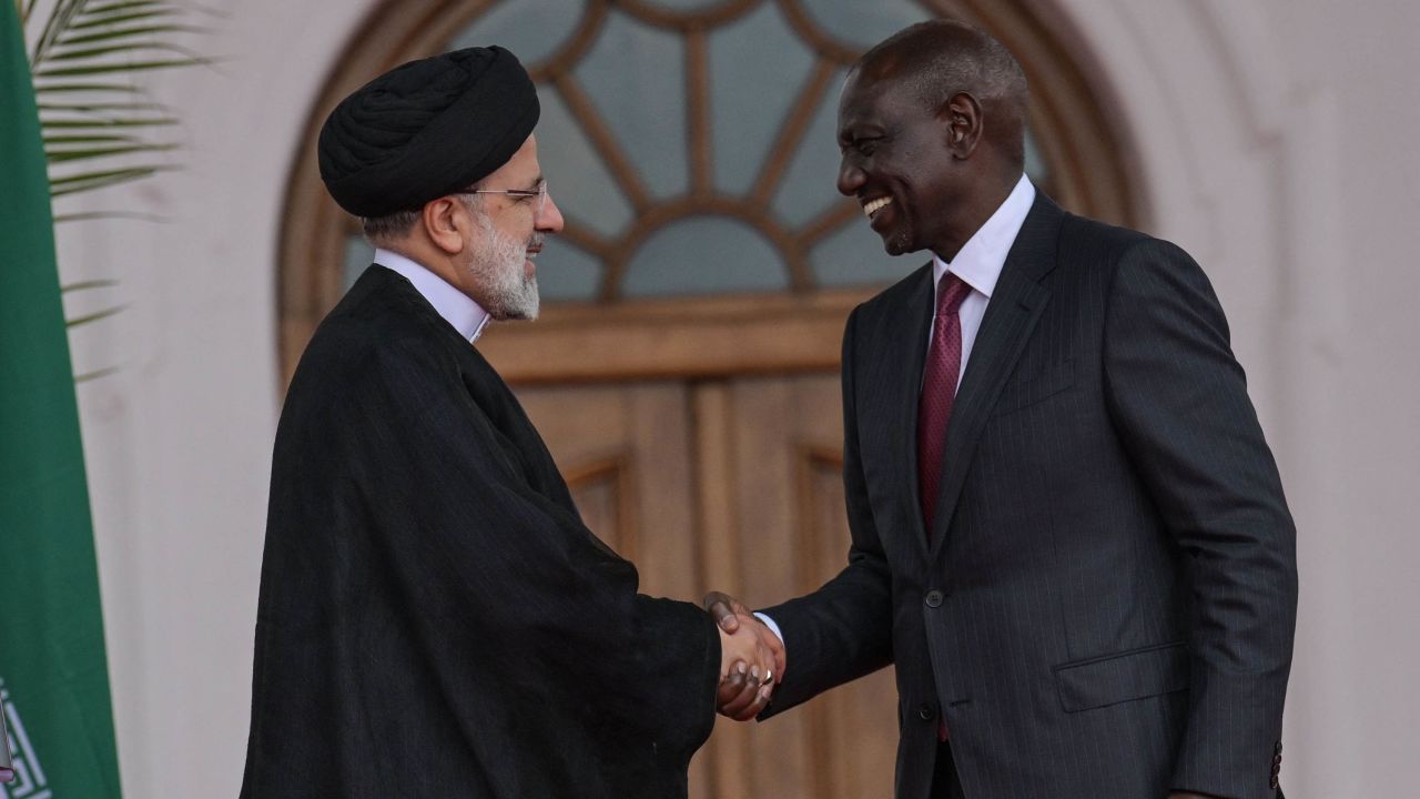 Iranian President Ebrahim Raisi (L) shakes hands with Kenyan President William Ruto (R) after a press conference at the State House in Nairobi on July 12, 2023.