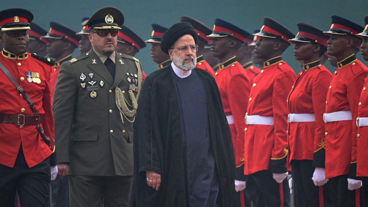 Iranian President Ebrahim Raisi (C) inspects the guard of honour during his state visit at the State House in Nairobi on July 12, 2023.