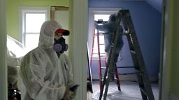 ** FILE ** In this Feb. 23, 2006 file photo, contractors Luis Benitez, foreground, and Jose Diaz, background, clean up lead paint at a contaminated building in Providence, R.I.   As of Thursday, contractors across the country will have to take additional precautions when renovating houses where children could be exposed to harmful lead dust from old paint, which could add thousands of dollars to renovation projects and cripple an industry already reeling from the recession. (AP Photo/Chitose Suzuki)