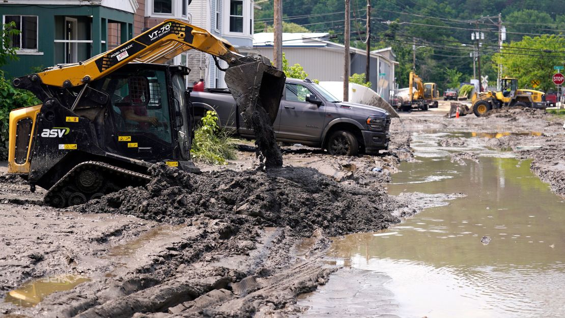 Equipment clears mud from a neighborhood Wednesday in Barre, Vermont.
