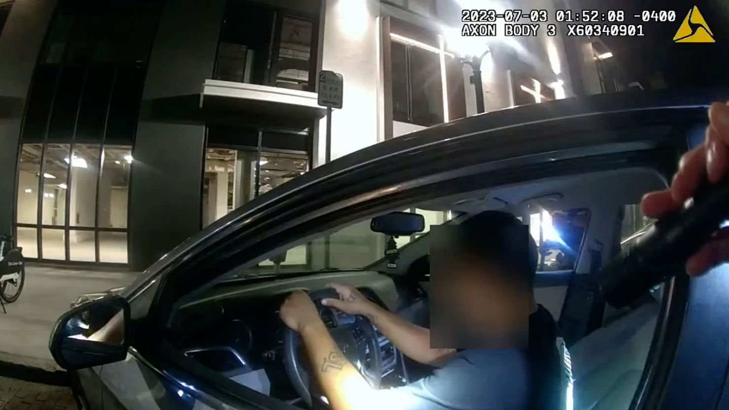 In body camera footage released by Orlando Police Wednesday, Diaz is seen sitting in his parked car when he is approached by several police officers. At one poine, Diaz reaches his right hand toward the vehicle's center console before an officer fires what sounds like a single gunshot. Less than a minute elapses in the encounter before the officer shoots Diaz.