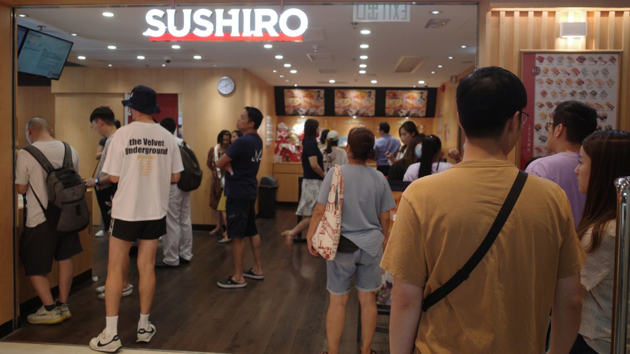 Customers wait to get into Japanese sushi chain Sushiro in Causeway Bay, Hong Kong, on July 13, 2023.