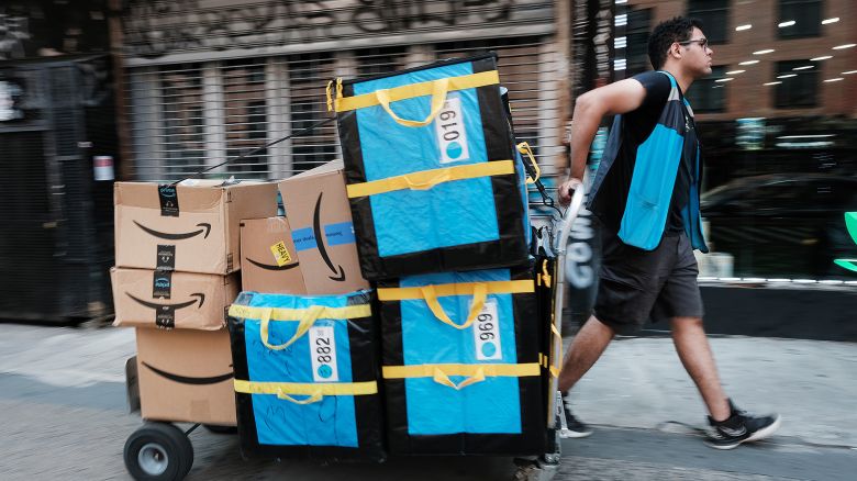 An Amazon worker moves boxes on Amazon Prime Day on July 11, 2023 in the East Village of New York City. Amazon holds the annual two-day event, where it offers shopping deals to Prime customers, in the middle of the summer. Amazon Prime Day has brought an estimated 10 billion dollars to the company in each of the last 3 years, as customers look to take advantage of discounts and quick shipping.