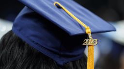 A tassel with 2023 on it rests on a graduation cap as students walk in a procession for Howard University's commencement in Washington, Saturday, May 13, 2023. 
