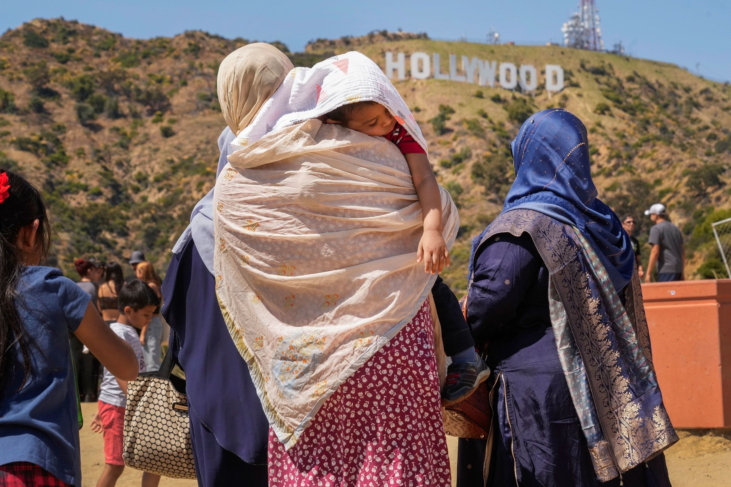 A sleeping child is protected from the sun in Los Angeles on July 12.