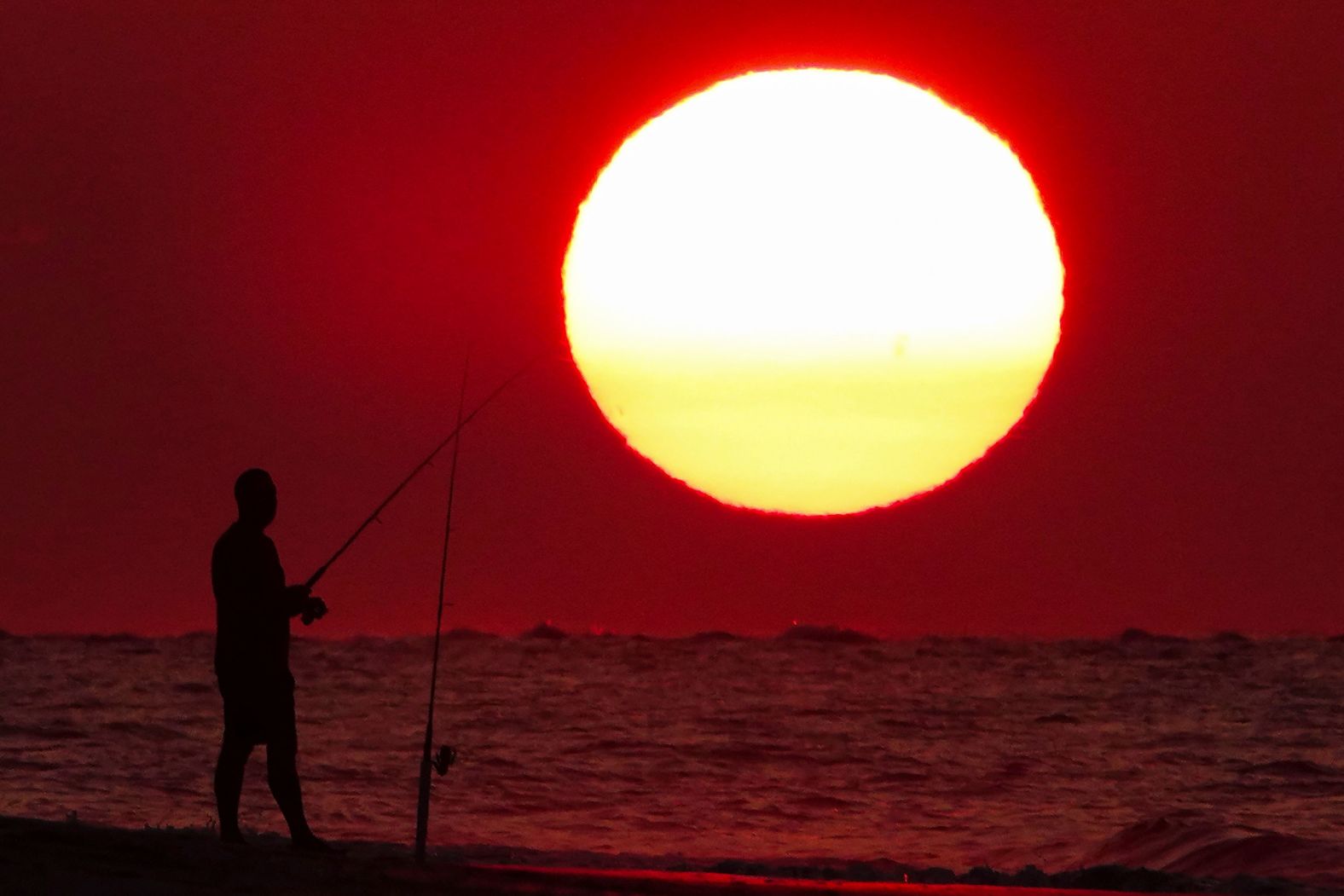 A person fishes in Isle of Palms, South Carolina, on July 12.