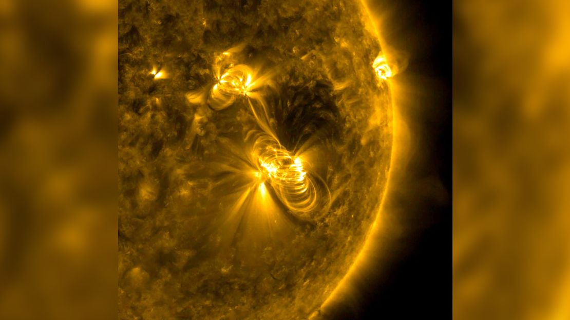 A medium-sized (M2) solar flare and a coronal mass ejection (CME) erupted from the same, large active region of the sun on July 14, 2017. The flare lasted almost two hours, quite a long duration. The coils arcing over this active region are particles spiraling along magnetic field lines, which were reorganizing themselves after the magnetic field was disrupted by the blast. Images were taken in a wavelength of extreme ultraviolet light.