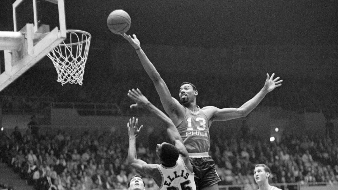 Wilt Chamberlain during his playing days with the Philadelphia 76ers, here against the LA Lakers, with Jerry West (right) looking on.