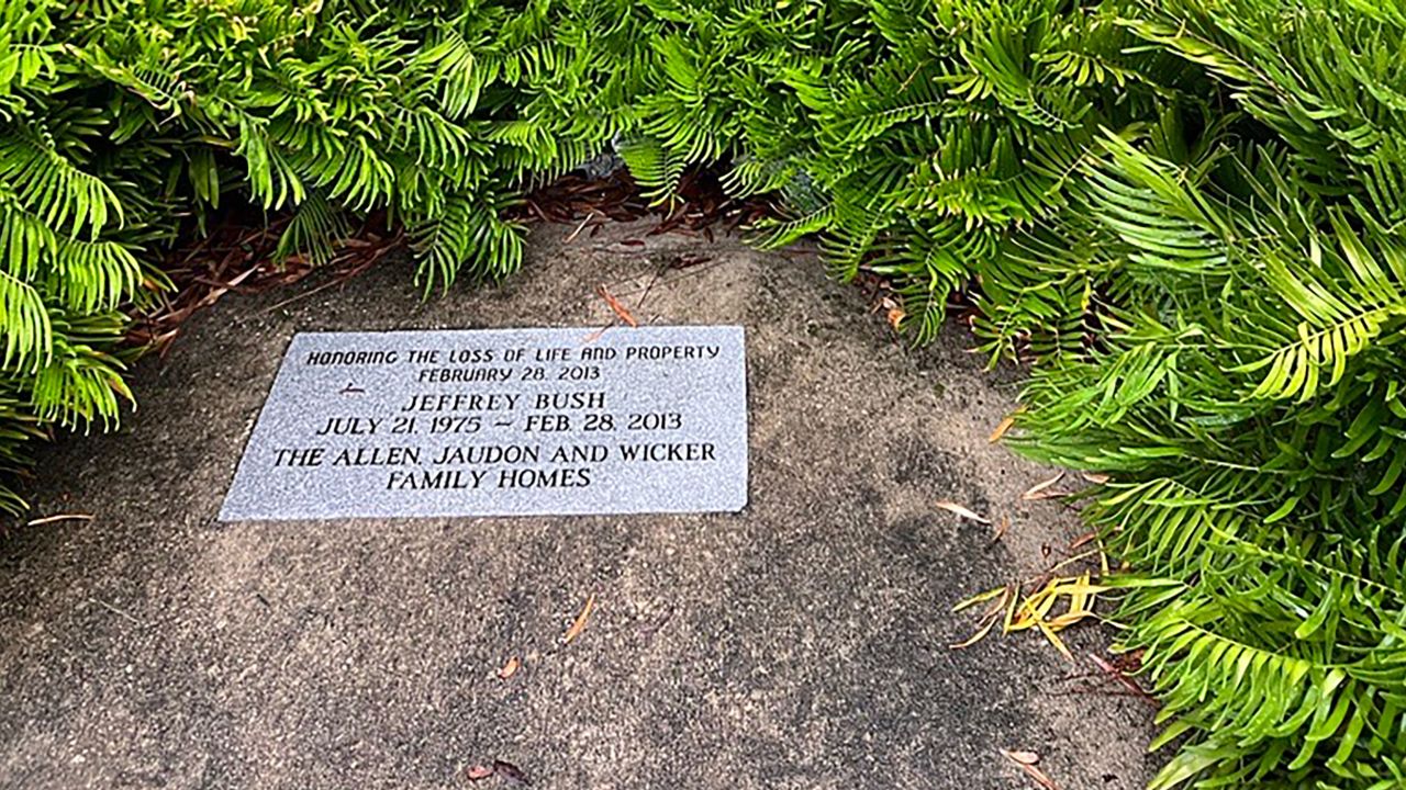 A memorial for Jeffrey Bush is seen near a sinkhole that reopened. 