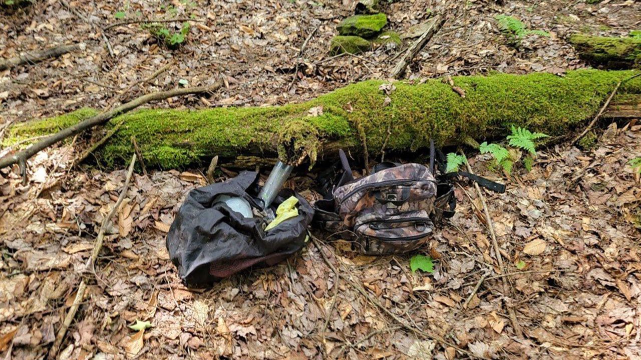 A bag covered by a tarp and hidden under a log was almost certainly used by Michael Burham, who has been on the run for about a week since escaping a jail in northwestern Pennsylvania, a state patrol official said Thursday.
