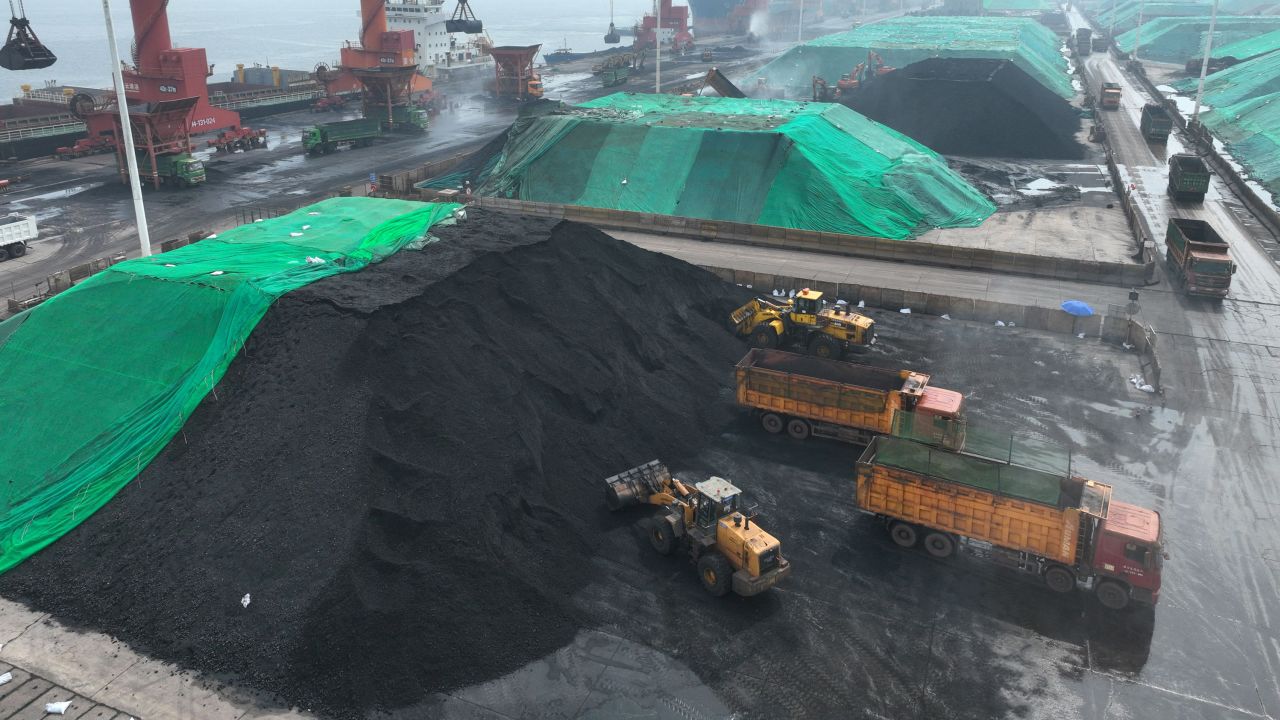 Coal is loaded onto trucks for delivery to power generation plants, after being unloaded from ships at the port in Lianyungang, in China's eastern Jiangsu province on July 12, 2023.
