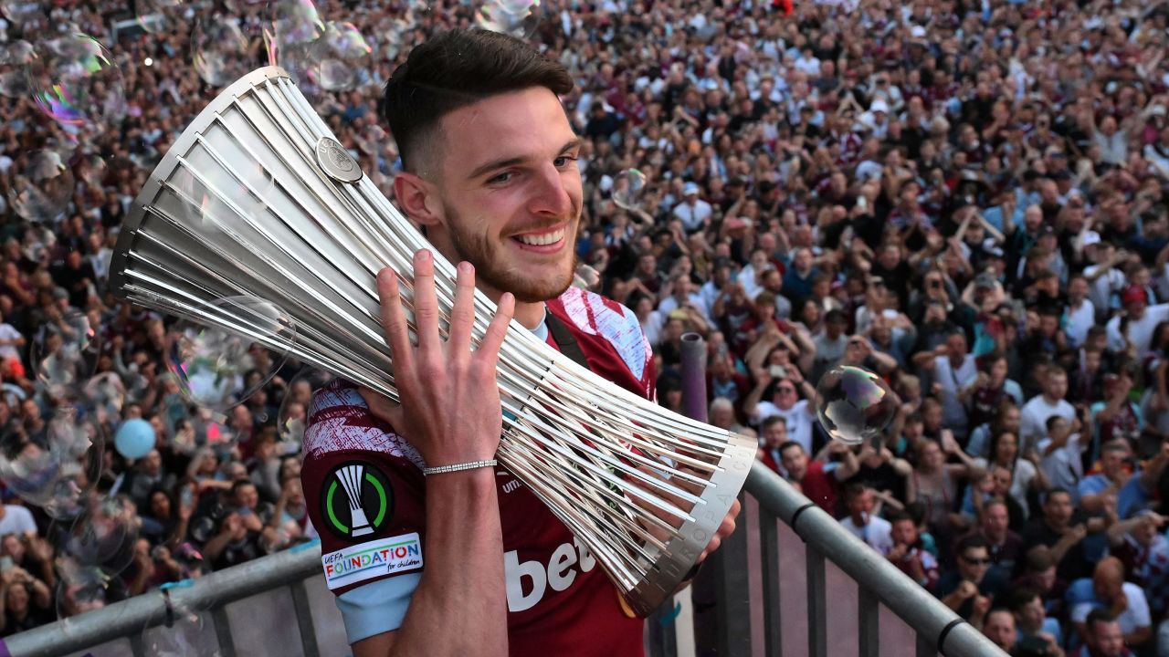 West Ham United's English midfielder Declan Rice holds the UEFA Europa Conference League trophy on stage at the Town Hall in Stratford, east London on June 8, 2023, following an open-top bus during a parade to celebrate the team winning the football final against Fiorentina. (Photo by Daniel LEAL / AFP) (Photo by DANIEL LEAL/AFP via Getty Images)