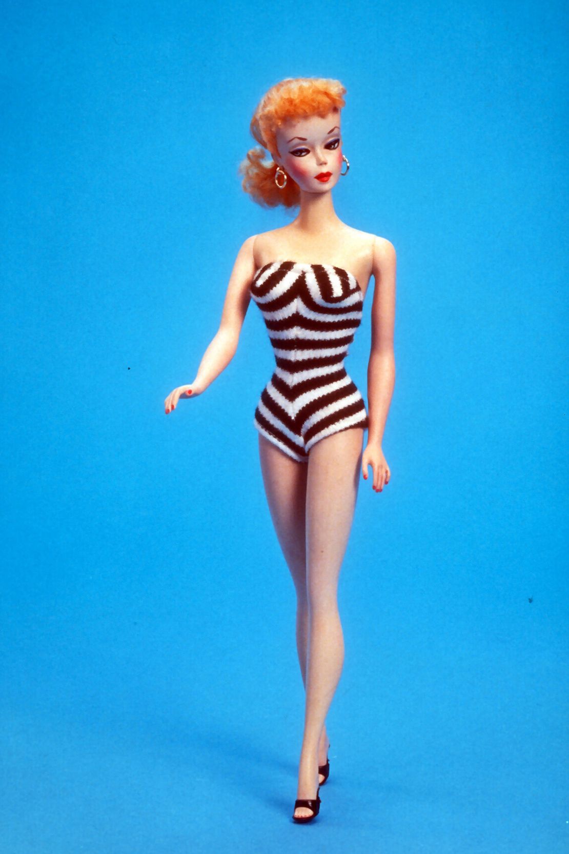 With her fitted one piece, high heels and a full face of makeup, the original Barbie offered a glamorous  take on poolside fashion.