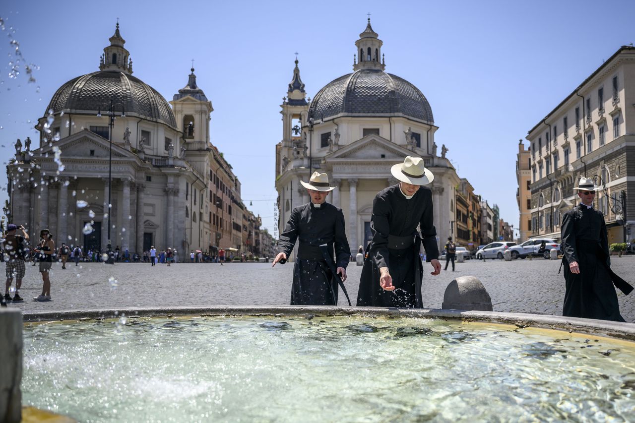 People cool off at Piazza del Popolo in Rome on July 10. 