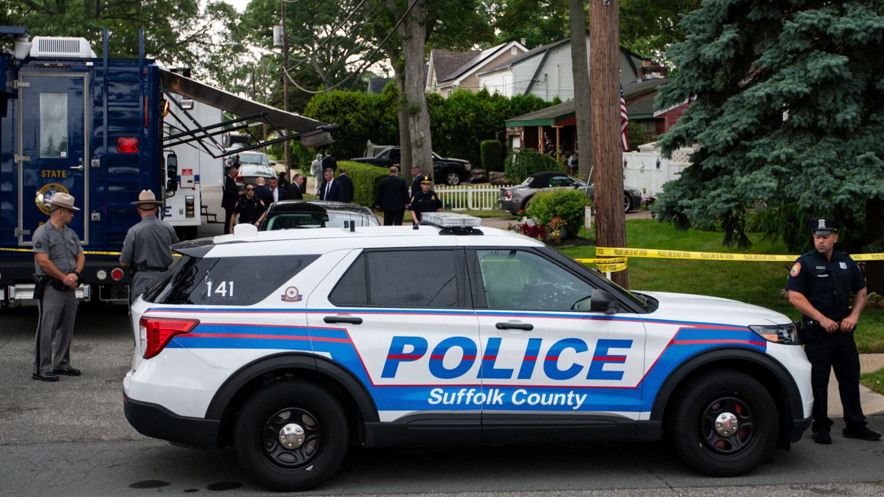 Law enforcement arrive to a house Friday, July 14, 2023, as sources said a suspect has been taken into custody in connection with a long-unsolved string of killings on New York's Long Island.