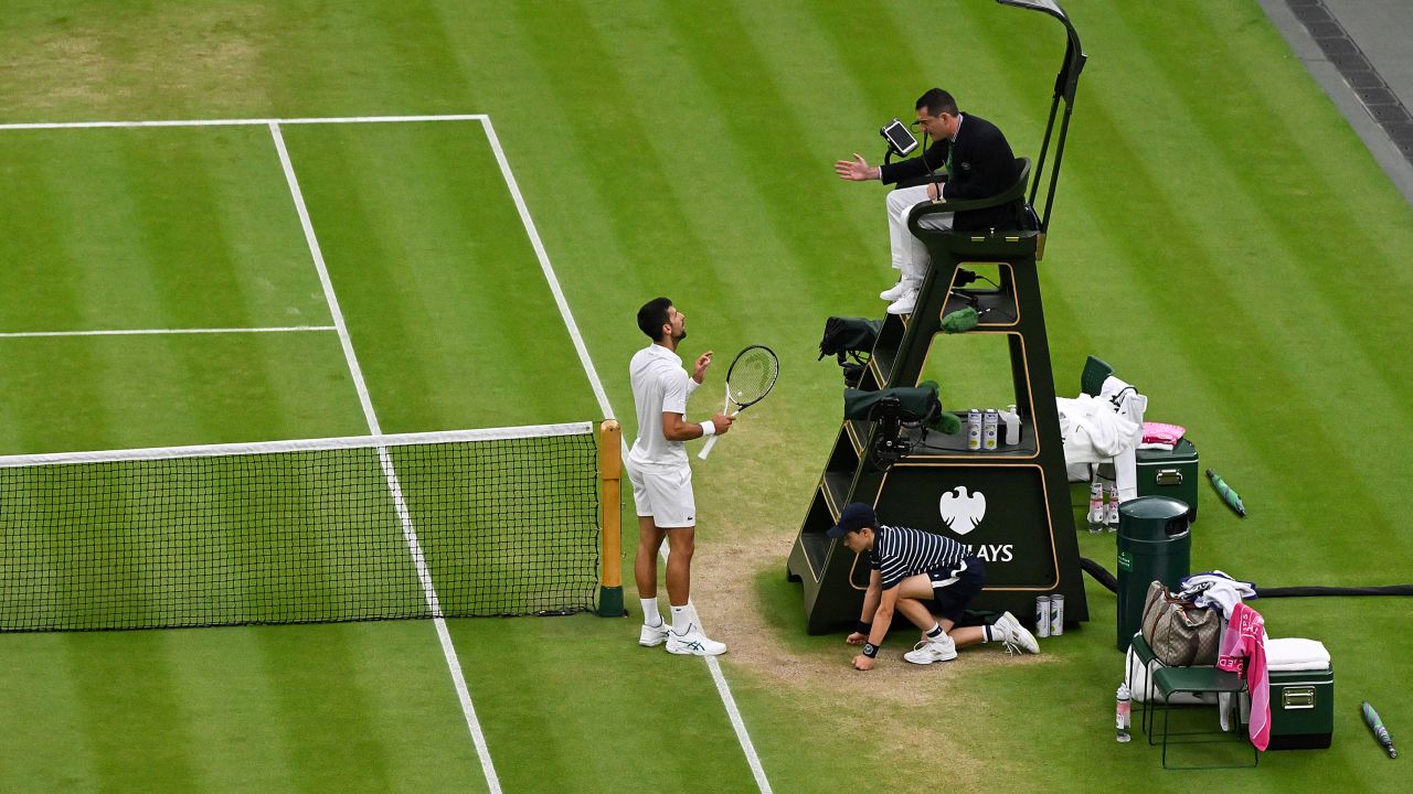 Djokovic argues with the umpire following a point deduction for shouting.