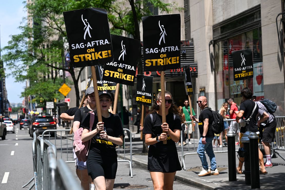 Members of the Writers Guild of America East and SAG-AFTRA walk the picket line outside NBC Rockefeller Center on July 14, 2023 in New York City. Members of SAG-AFTRA, Hollywood's largest union which represents actors and other media professionals, have joined striking WGA (Writers Guild of America) workers in the first joint walkout against the studios since 1960. The strike could shut down Hollywood productions completely with writers in the third month of their strike against the Hollywood studios. 