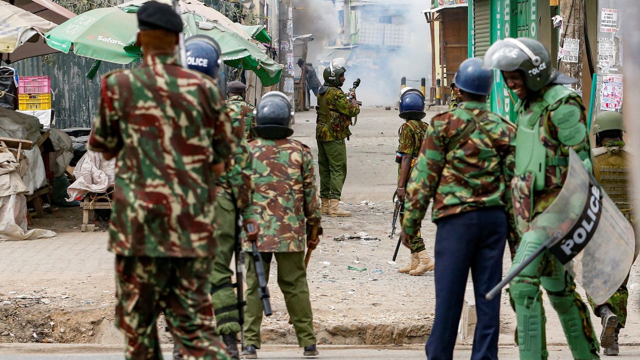 Riot police officer lobs teargas canisters to disperse supporters of Kenya's opposition leader Raila Odinga as they participate in an anti-government protest against the imposition of tax hikes by the government, in Mlolongo settlement of Machakos county, Kenya July 12, 2023.