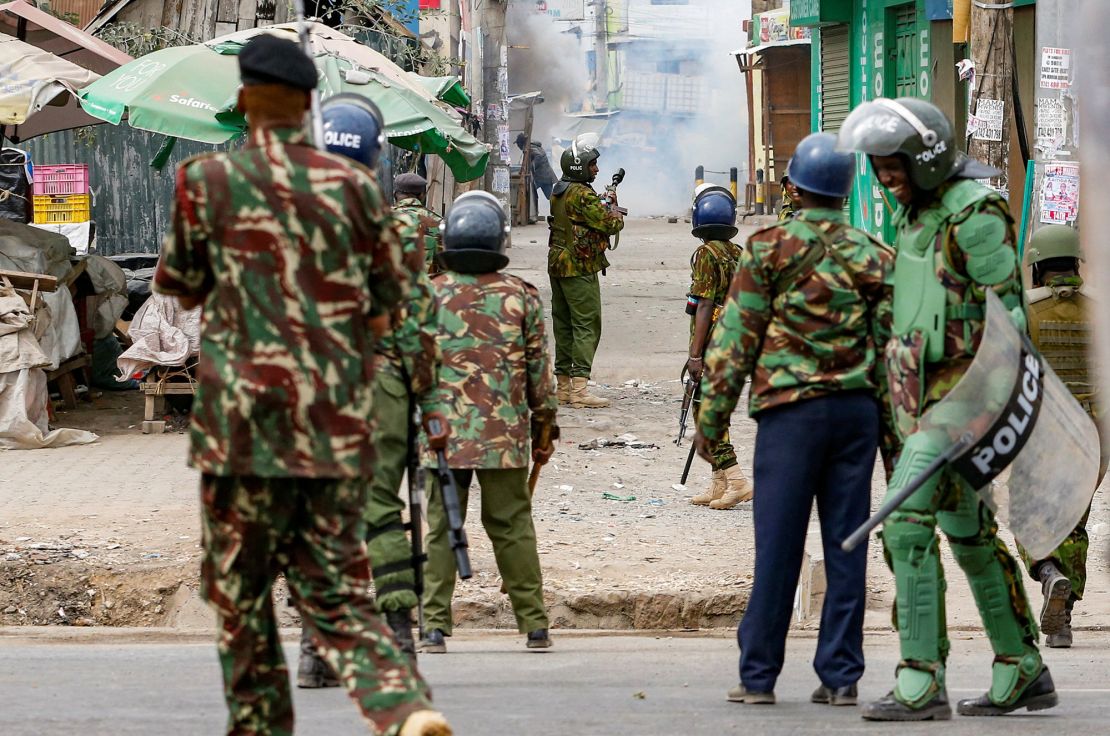 Riot police officer lobs teargas canisters to disperse supporters of Kenya's opposition leader Raila Odinga as they participate in an anti-government protest against the imposition of tax hikes by the government, in Mlolongo settlement of Machakos county, Kenya July 12, 2023.