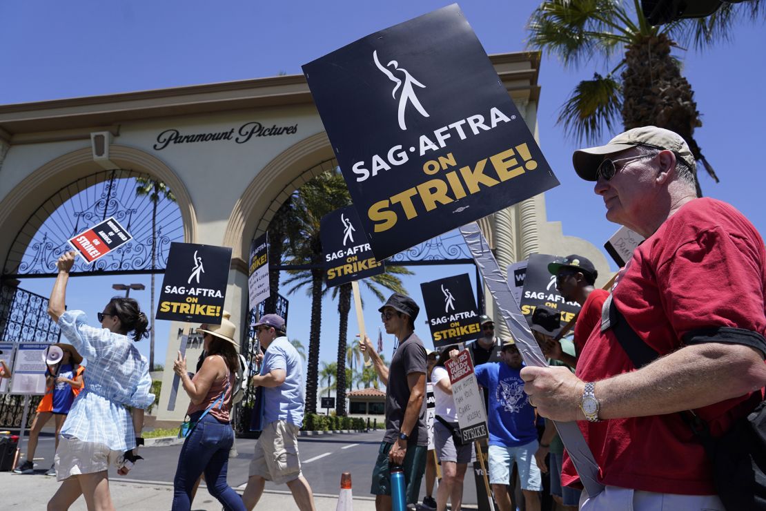 Striking writers and actors take part in a rally outside Paramount studios in Los Angeles on Friday, July 14, 2023. This marks the first day actors formally joined the picket lines, more than two months after screenwriters began striking in their bid to get better pay and working conditions.