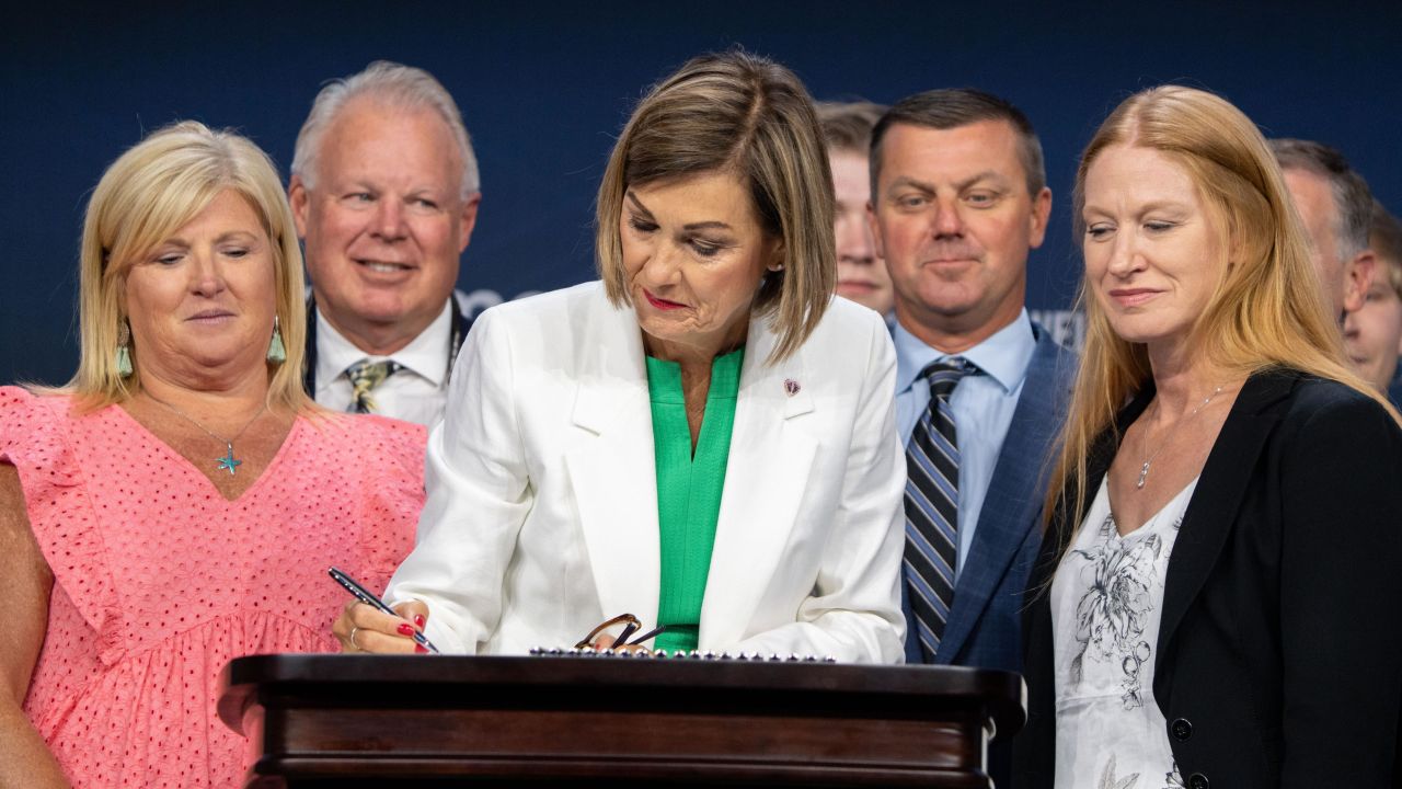 Gov. Kim Reynolds signs a 6-week 'fetal heartbeat' abortion ban during the Family Leadership Summit in Des Moines, Friday, July 14, 2023.