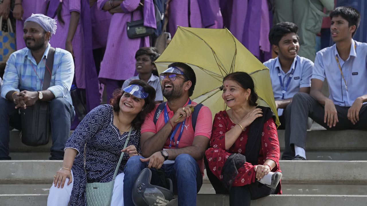 People listen to a live broadcast of scientists speaking after the launch of spacecraft Chandrayaan-3.