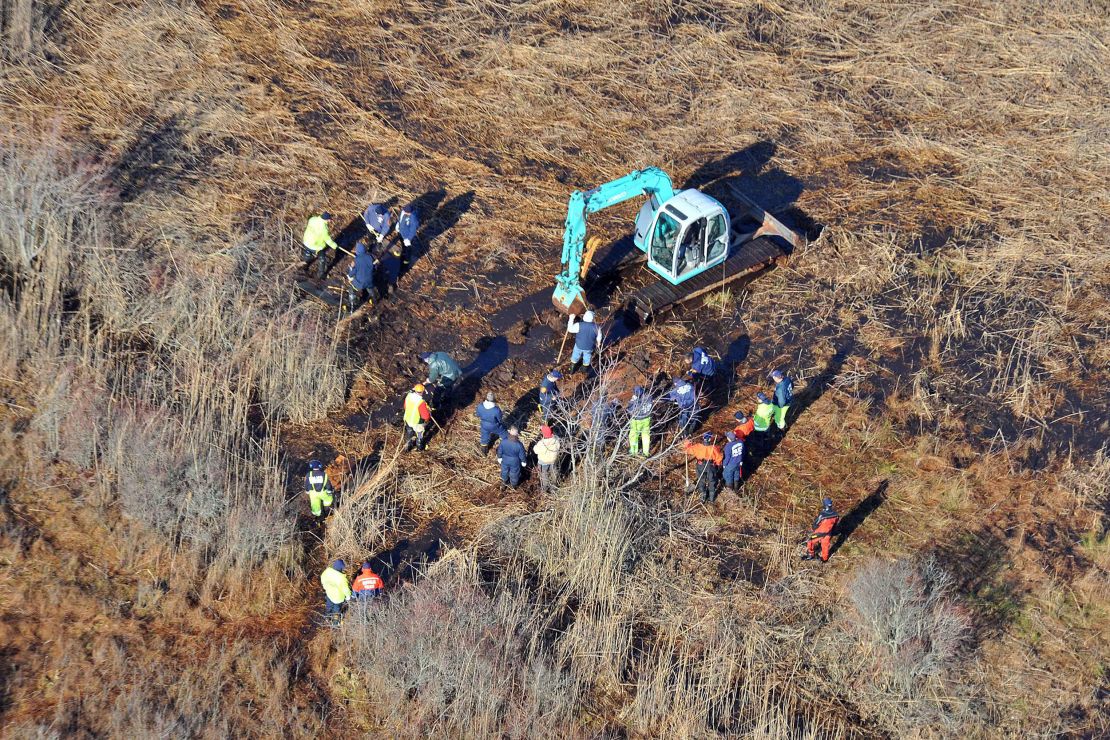 In this December 8, 2011 photo, investigators use a backhoe to dig while searching for Shannan Gilbert's body in a marsh area just east of Oak Beach, New York. 