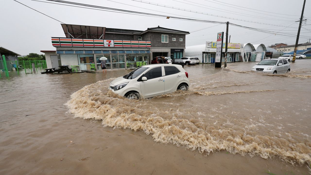 A vehicle makes its way through a flooded area caused by heavy rain in Cheongju, South Korea, July 15, 2023.   Yonhap/via REUTERS       ATTENTION EDITORS - THIS IMAGE HAS BEEN SUPPLIED BY A THIRD PARTY. NO RESALES. NO ARCHIVE. SOUTH KOREA OUT. NO COMMERCIAL OR EDITORIAL SALES IN SOUTH KOREA.