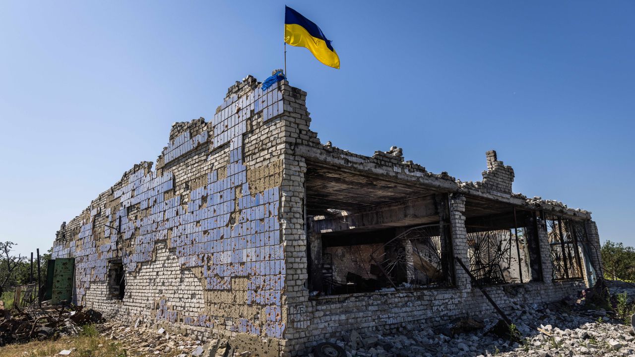 A Ukrainian flag waves above a destroyed building after shelling in Vremivka, Ukraine, on July 6.