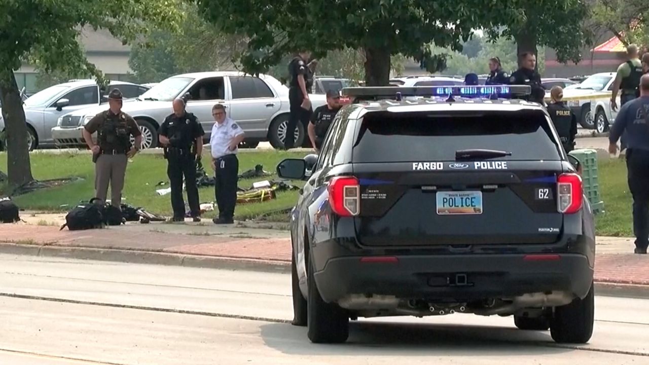 In this image from video, law enforcement officers work at the scene of a shooting Friday, July 14, 2023, in Fargo, North Dakota.