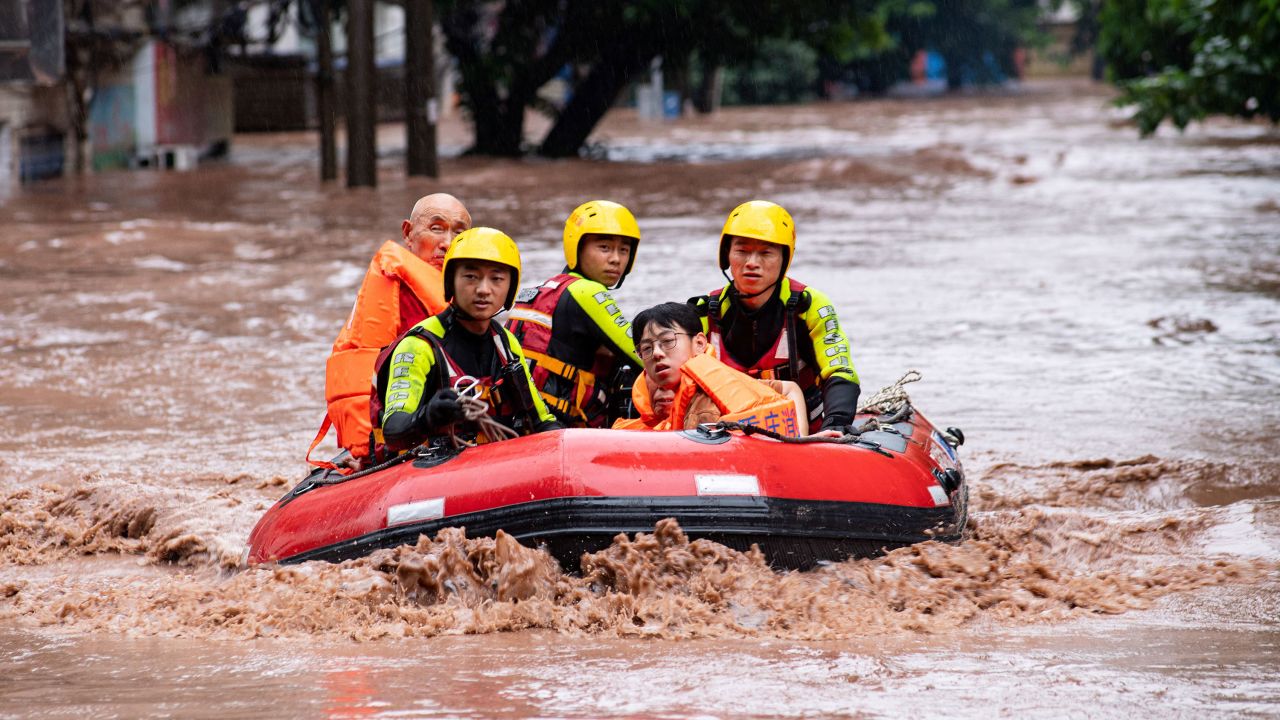 Rescue workers evacuate stranded residents after heavy rainfall in Chongqing, China.
