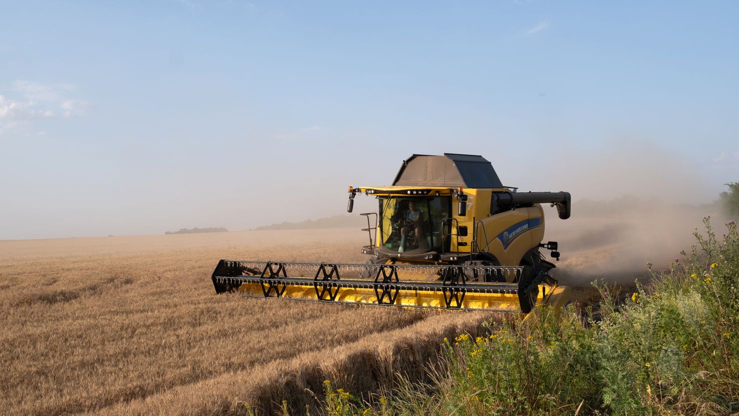 Harvester works on a wheat fields near ongoing Ukrainian counter-offensive in Prymorske, Ukraine on July 5, 2023. 