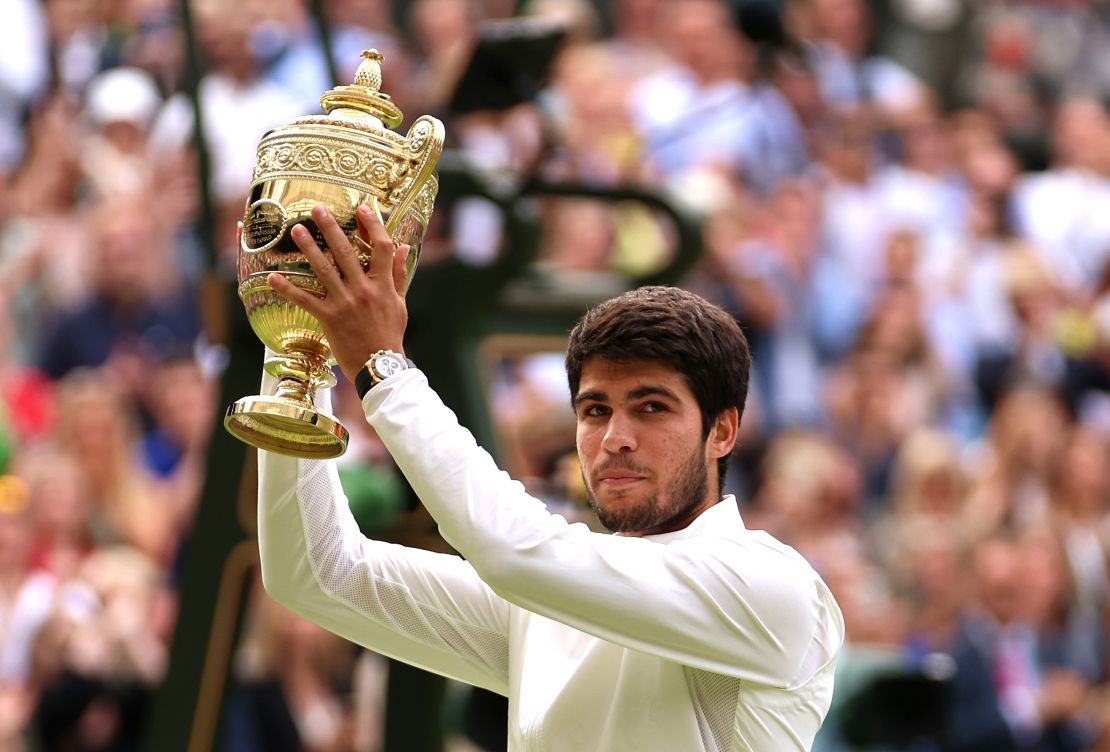 Carlos Alcaraz of Spain lifts the Men's Singles Trophy following his victory in the Men's Singles Final against Novak Djokovic of Serbia on day fourteen of The Championships Wimbledon 2023 at All England Lawn Tennis and Croquet Club on July 16, 2023 in London, England.
