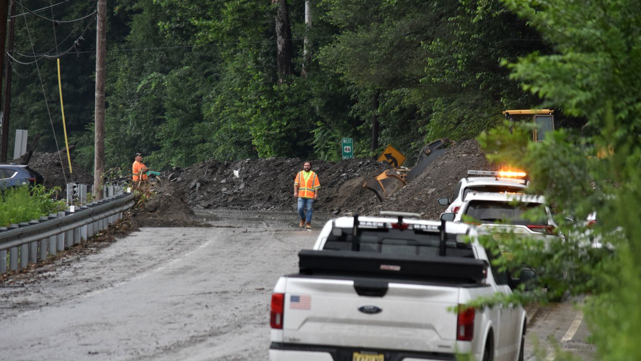 Municipal workers conduct cleaning work after landslide following heavy rains in New Jersey.