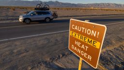 FURNACE CREEK, CALIFORNIA - JULY 15: A car passes a sign warning of extreme heat danger on the eve of a day that could set a new world heat record in Death Valley National Park on July 15, 2023 near Furnace Creek, California. Weather forecasts for tomorrow call for a high temperature of 129º Fahrenheit and possibly as high as 131.  Previously, the highest temperature reliably recorded on Earth was 129.2F (54C) in Death Valley in 2013. A century earlier a high temperature in Death Valley reportedly reached 134F but many modern weather experts have rejected that claim along with other high summer temperatures reported in the region that year.  (Photo by David McNew/Getty Images)