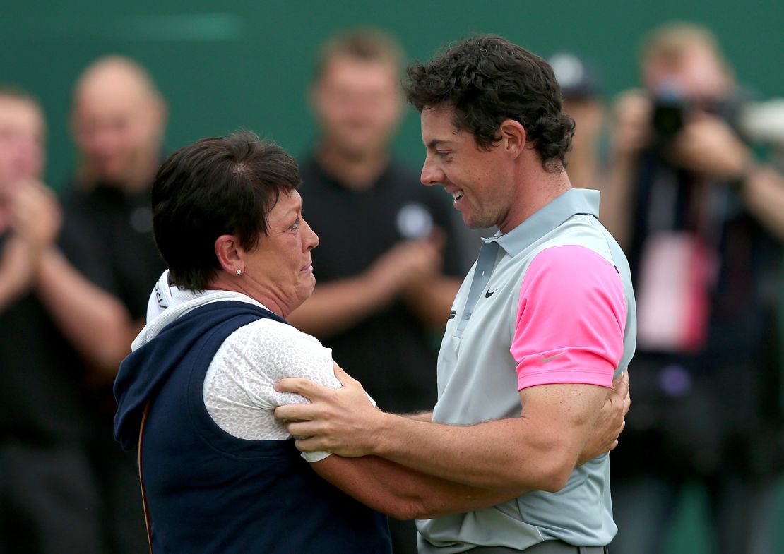 Northern Ireland's Rory McIlroy celebrates with his mother Rosie on the 18th green winning the Open Championship after his fourth round 71, on the final day of the 2014 British Open Golf Championship at Royal Liverpool Golf Course in Hoylake, north west England on July 20, 2014. McIlroy won the British Open at Royal Liverpool Golf Course in Hoylake with a final round of 71. The 25-year-old Northern Irishman won with a seventeen under par total of 271, two strokes clear of Rickie Fowler and Sergio Garcia. AFP PHOTO / ANDREW YATES        (Photo credit should read ANDREW YATES/AFP via Getty Images)