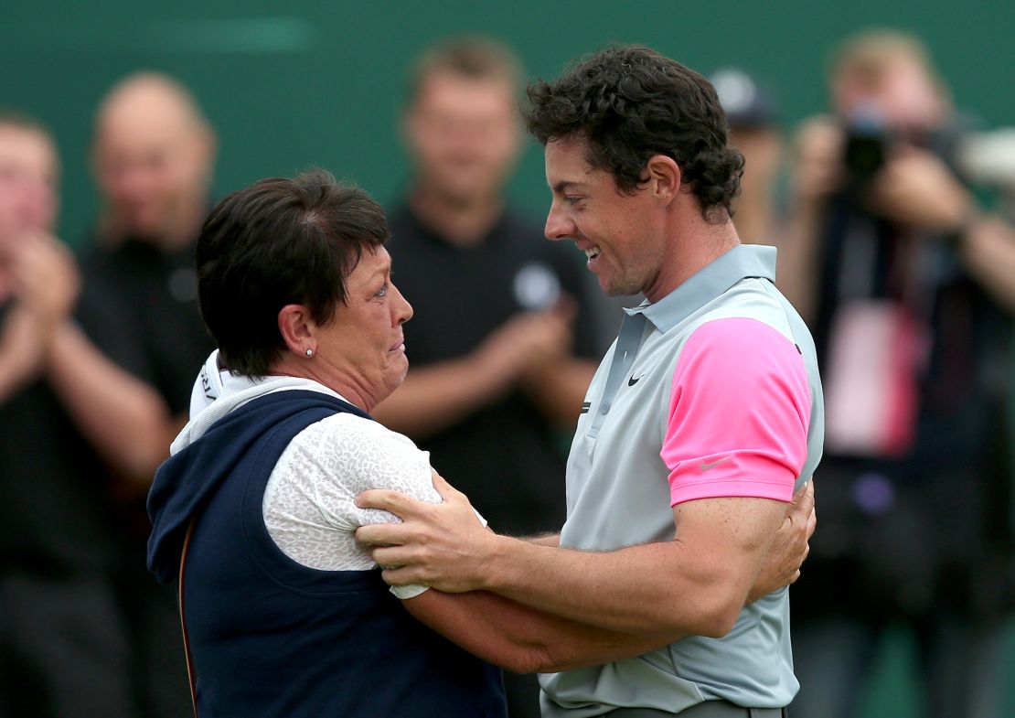 Northern Ireland's Rory McIlroy celebrates with his mother Rosie on the 18th green winning the Open Championship after his fourth round 71, on the final day of the 2014 British Open Golf Championship at Royal Liverpool Golf Course in Hoylake, north west England on July 20, 2014. McIlroy won the British Open at Royal Liverpool Golf Course in Hoylake with a final round of 71. The 25-year-old Northern Irishman won with a seventeen under par total of 271, two strokes clear of Rickie Fowler and Sergio Garcia. AFP PHOTO / ANDREW YATES (Photo credit should read ANDREW YATES/AFP via Getty Images)