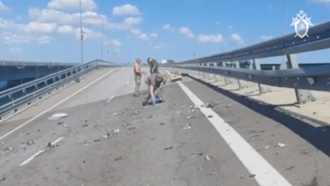 Russian investigators work at the scene on the section of the bridge damaged on July 17, 2023.