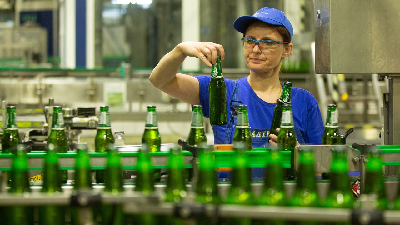 A worker inspects beer bottles at a Baltika Breweries plant in St. Petersburg, Russia, in May 2018.