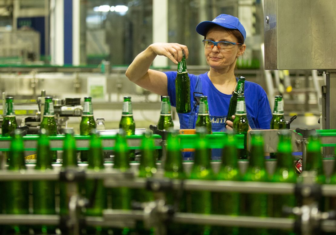 A worker inspects beer bottles at a Baltika Breweries plant in St. Petersburg, Russia, in May 2018.