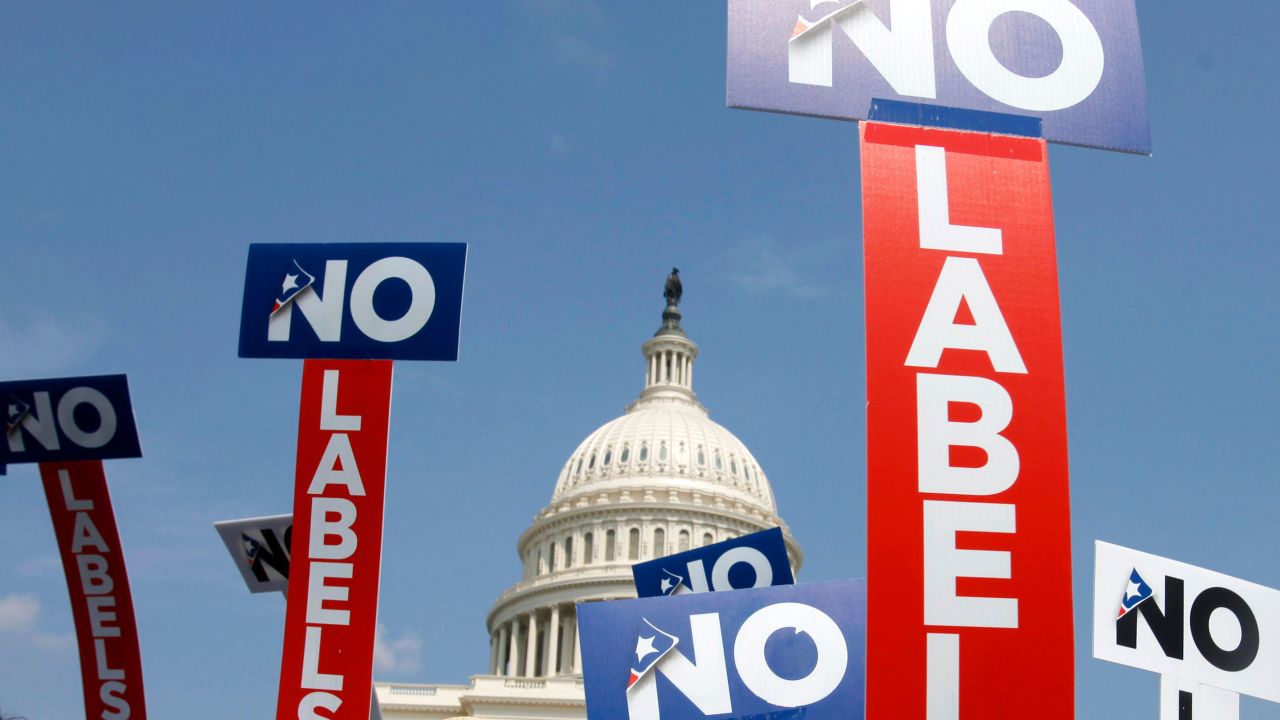 In this July 2011 photo, people with the group No Labels hold signs during a rally on Capitol Hill in Washington, DC.
