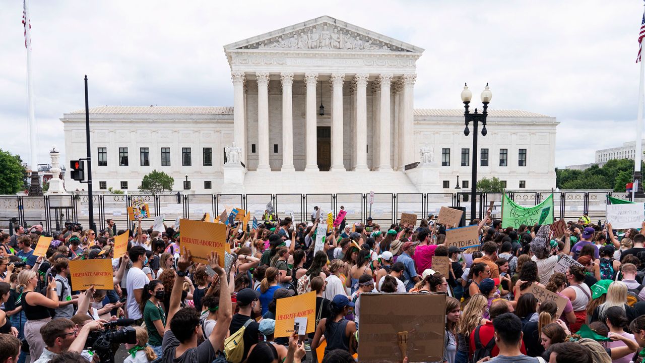 FILE - Protesters gather outside the Supreme Court in Washington, Friday, June 24, 2022, following Supreme Court's decision to overturn Roe v. Wade. Overturning Roe v. Wade and affirmative action in higher education had been leading goals of the conservative legal movement for decades. Over a span of 370 days, a Supreme Court reshaped by three justices nominated by President Donald Trump made both of those goals a reality. (AP Photo/Jacquelyn Martin, File)
