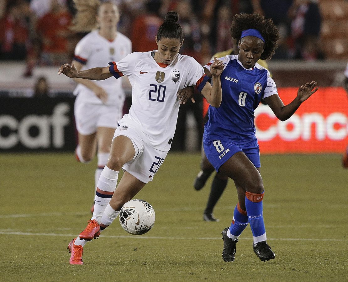 HOUSTON, TEXAS - JANUARY 28: Christen Press #20 of the United States competes for the ball with Danielle Etienne #8 of Haiti during a Group A CONCACAF Women's Olympic Qualifying match at BBVA Compass Stadium on January 28, 2020 in Houston, Texas. (Photo by Bob Levey/Getty Images)