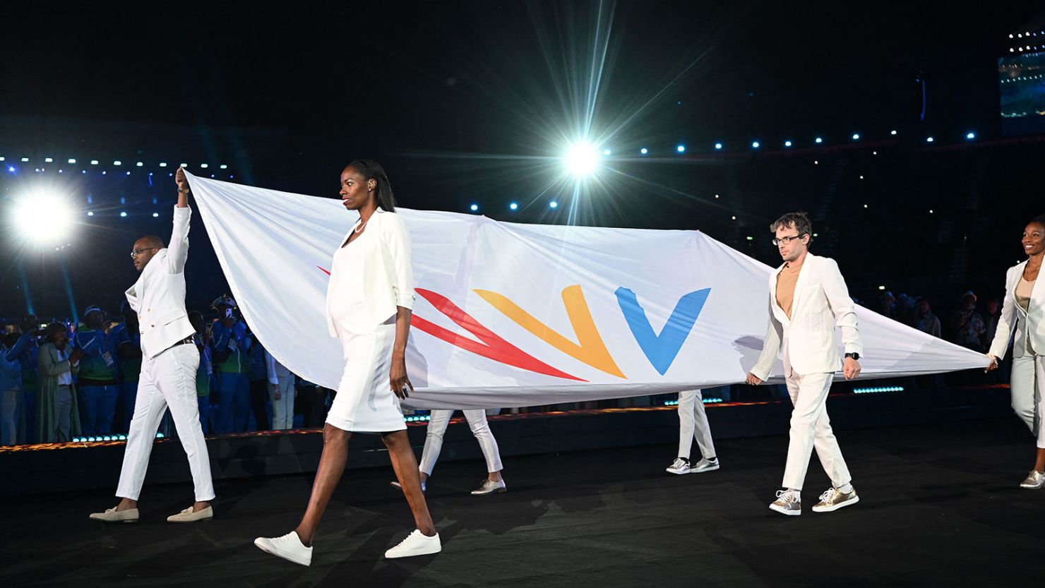 Athletes carry the Commonwealth Games Federation flag during the opening ceremony for the Commonwealth Games in Birmingham, central England, on July 28, 2022.